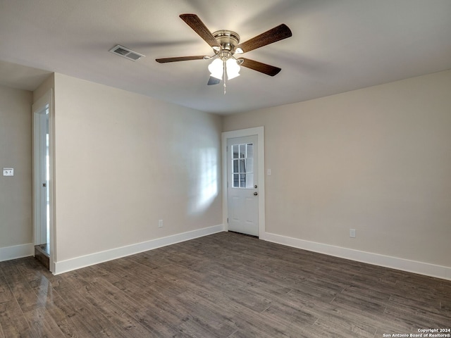 spare room featuring ceiling fan and dark hardwood / wood-style floors