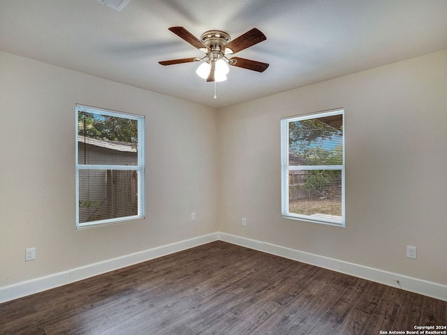 empty room featuring ceiling fan and dark hardwood / wood-style flooring