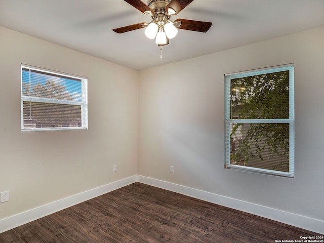 empty room featuring dark hardwood / wood-style flooring and ceiling fan