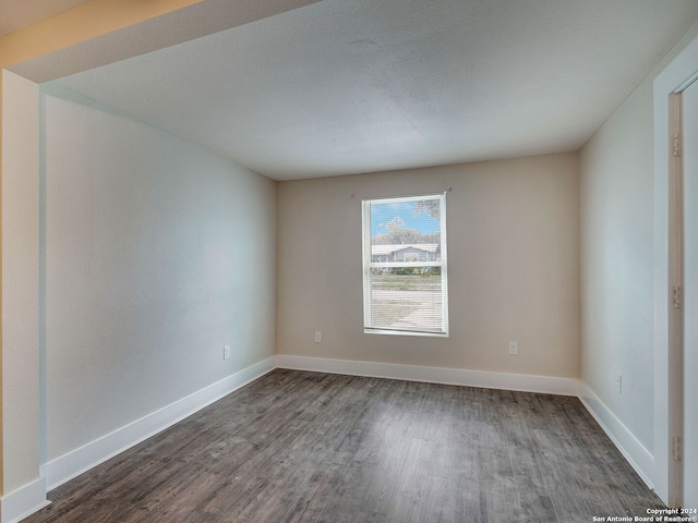 spare room featuring dark hardwood / wood-style flooring