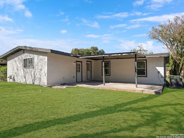 rear view of property featuring central air condition unit, a patio, and a yard