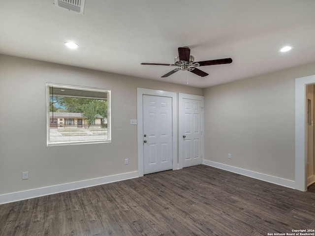 unfurnished bedroom featuring dark wood-type flooring and ceiling fan