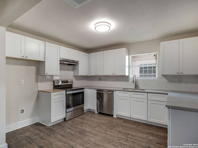 kitchen featuring dark hardwood / wood-style floors, white cabinetry, sink, and appliances with stainless steel finishes