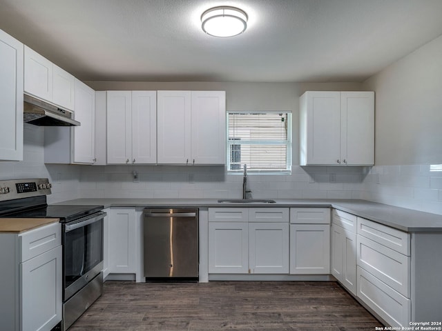 kitchen featuring white cabinetry, appliances with stainless steel finishes, dark wood-type flooring, and sink