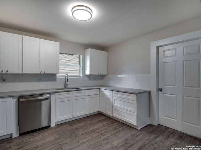 kitchen with dark wood-type flooring, decorative backsplash, sink, stainless steel dishwasher, and white cabinetry