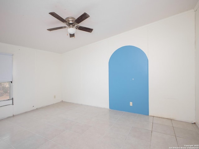 empty room with light tile patterned floors and a ceiling fan