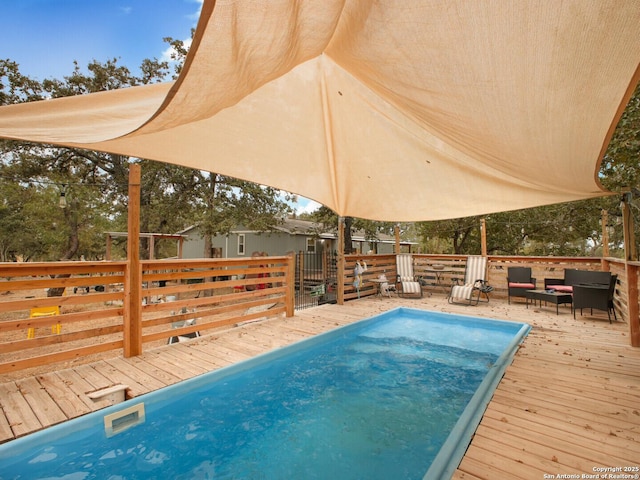 view of swimming pool featuring a deck