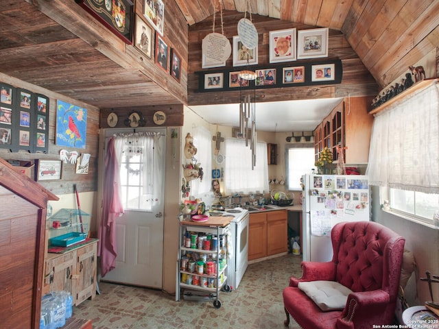 kitchen featuring lofted ceiling, white appliances, a sink, and wood ceiling