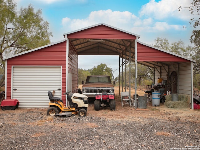 view of vehicle parking featuring a garage and a carport