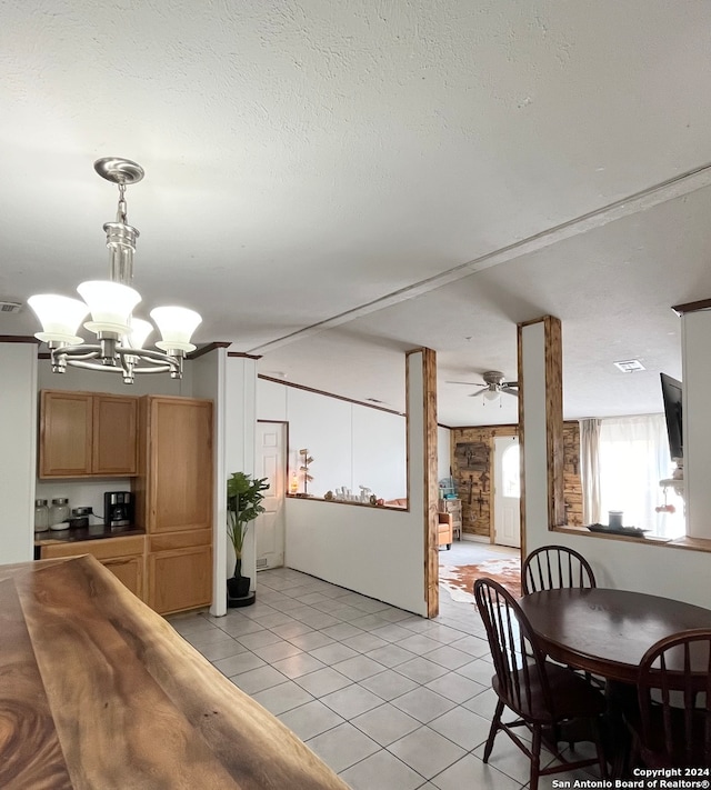 dining room featuring light tile patterned floors, ceiling fan with notable chandelier, and vaulted ceiling