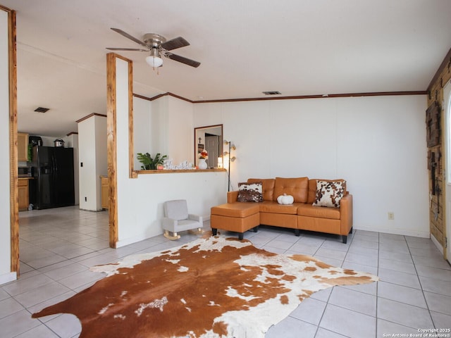 living area with ornamental molding, tile patterned flooring, visible vents, and a ceiling fan