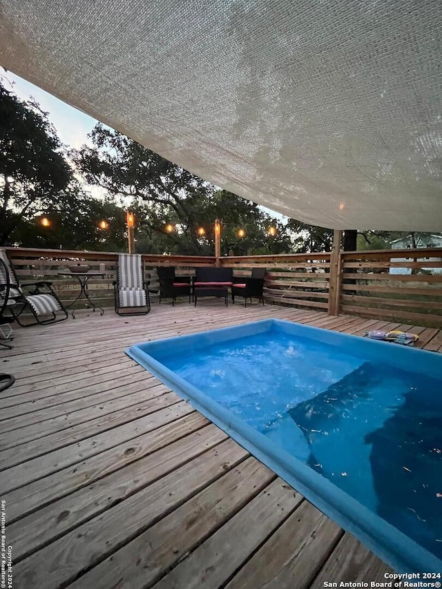 pool at dusk with a deck