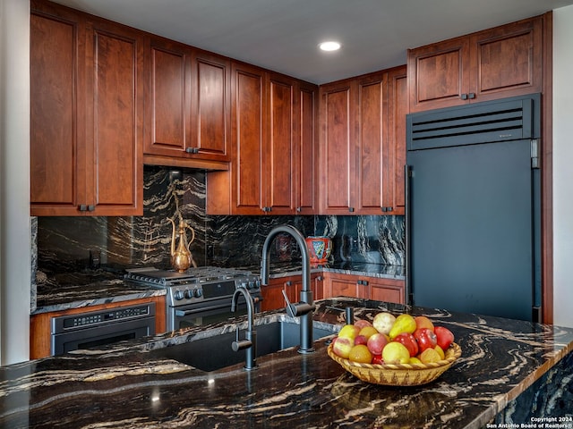 kitchen with dark stone countertops, backsplash, and high quality appliances