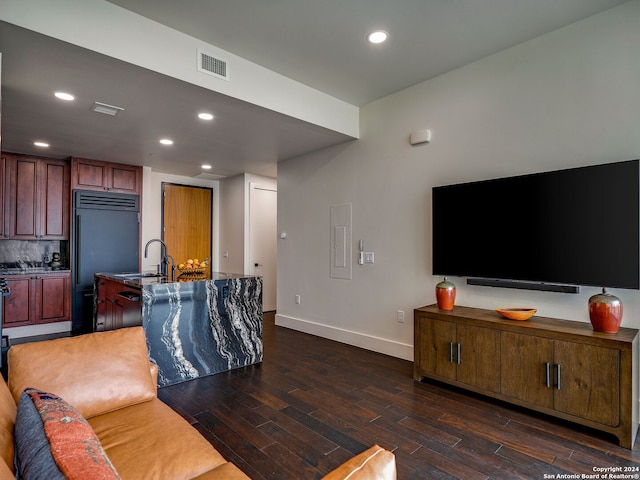 living room featuring dark wood-type flooring and sink