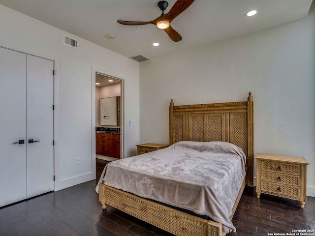 bedroom with a closet, ceiling fan, dark hardwood / wood-style floors, and connected bathroom