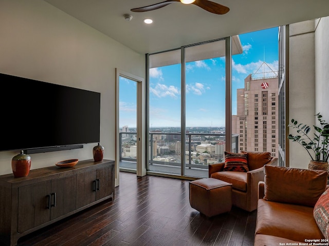 living room with floor to ceiling windows, ceiling fan, and dark hardwood / wood-style flooring