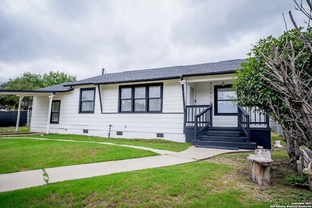 ranch-style house with covered porch and a front lawn