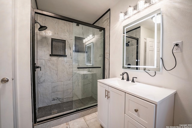 bathroom with vanity, tile patterned floors, and a shower with door