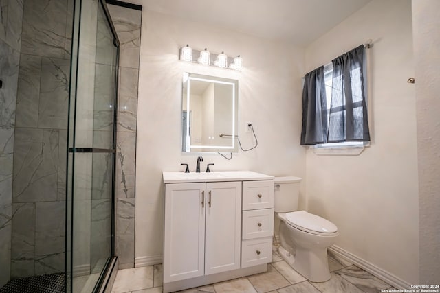 bathroom featuring toilet, a shower with door, and vanity