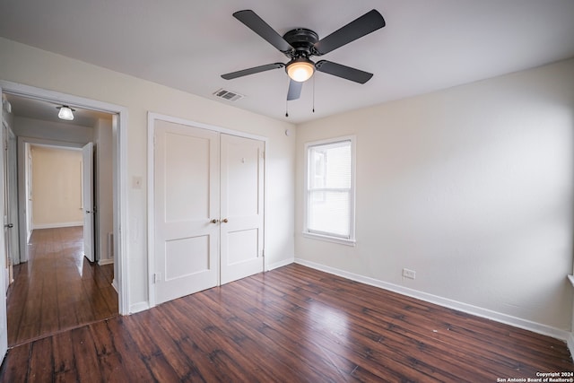 unfurnished bedroom with a closet, ceiling fan, and dark hardwood / wood-style floors