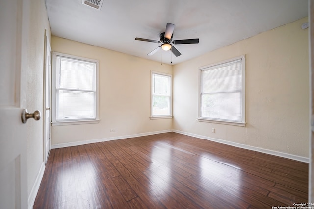 unfurnished room with plenty of natural light, ceiling fan, and dark hardwood / wood-style floors