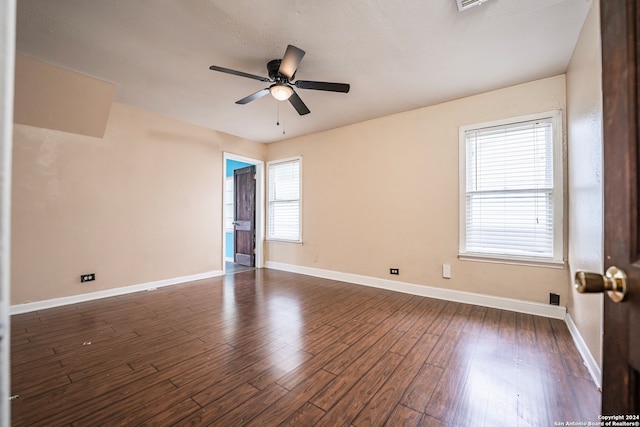 unfurnished room with ceiling fan and dark hardwood / wood-style floors