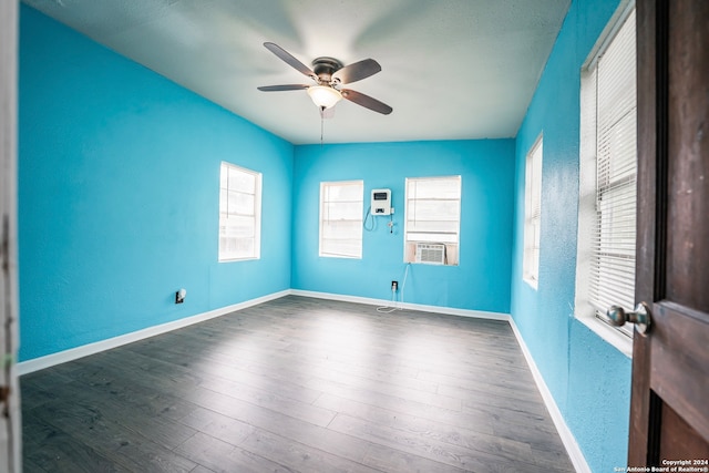 spare room with ceiling fan and dark hardwood / wood-style floors