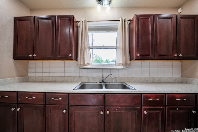 kitchen featuring tasteful backsplash and sink