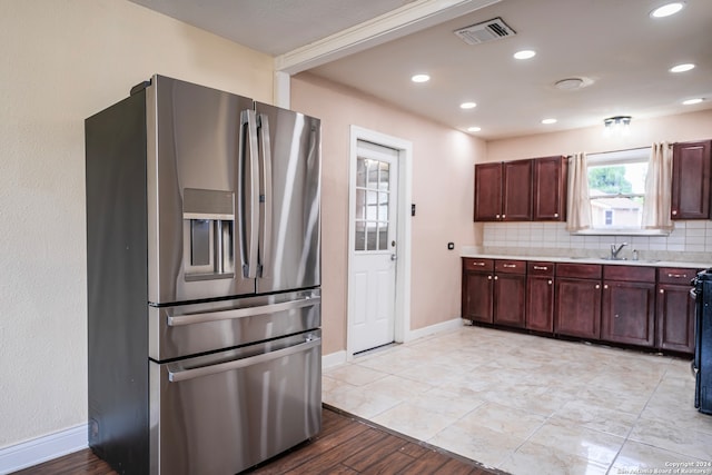 kitchen featuring stainless steel fridge, tasteful backsplash, and light hardwood / wood-style floors