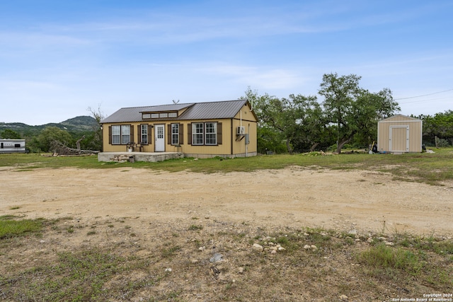 view of front of house with a storage unit