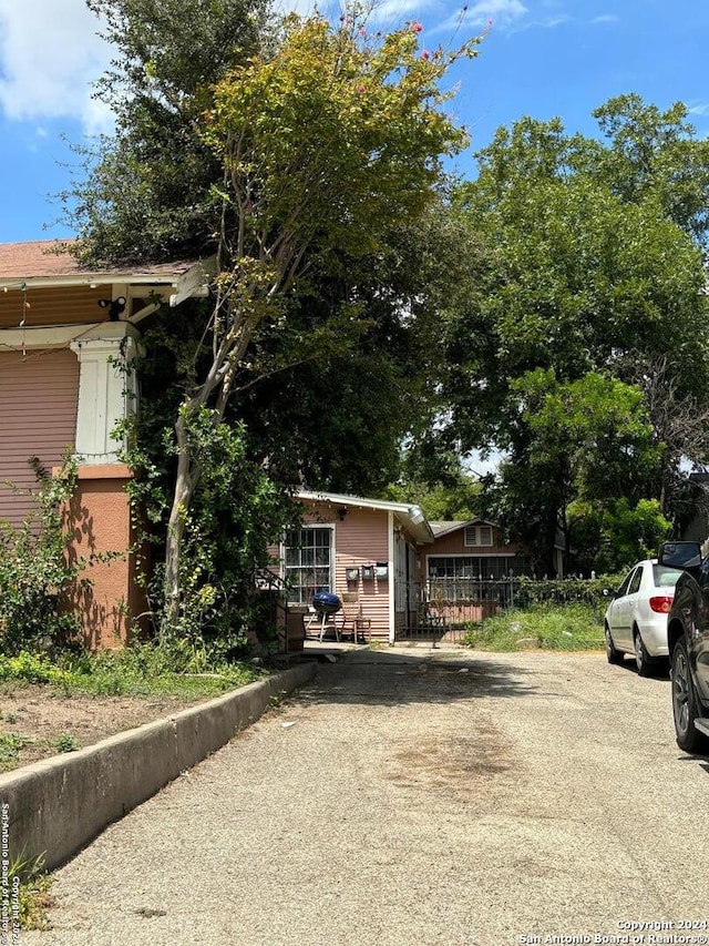 exterior space with fence and aphalt driveway