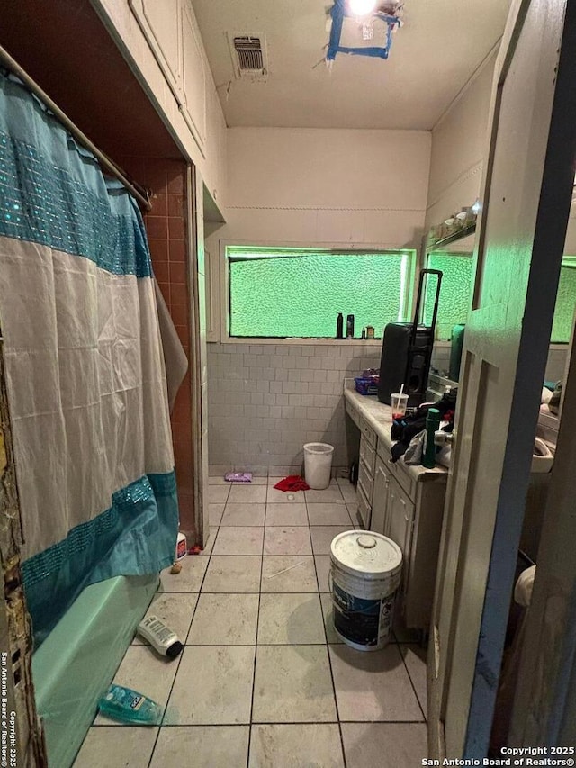 bathroom with tile patterned floors, visible vents, and vanity