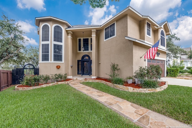 view of front facade featuring a garage and a front lawn