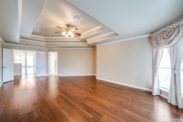 spare room with ornamental molding, ceiling fan, hardwood / wood-style flooring, and a tray ceiling