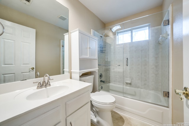 full bathroom with vanity, toilet, tile patterned flooring, and enclosed tub / shower combo