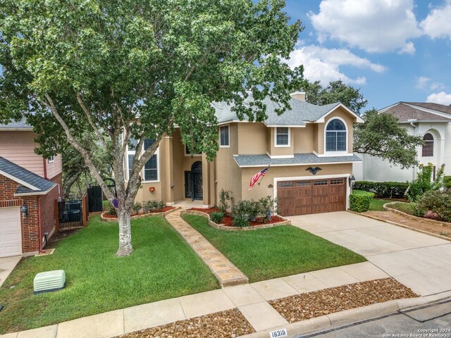 view of front of home featuring a front yard and a garage