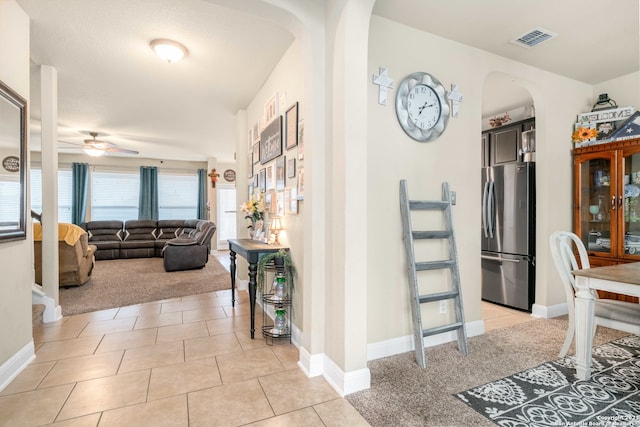 hallway featuring light tile patterned floors and a textured ceiling