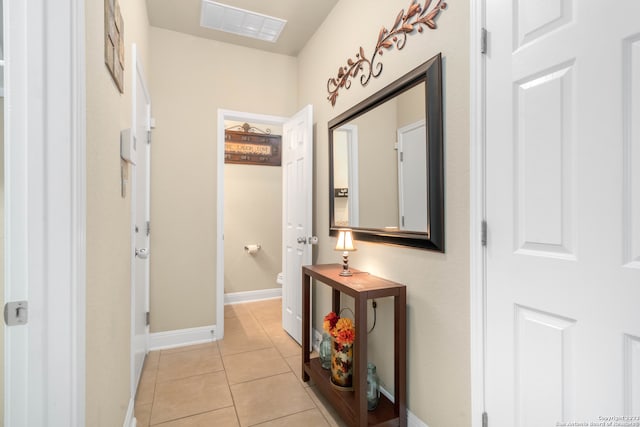 hall with light tile patterned floors