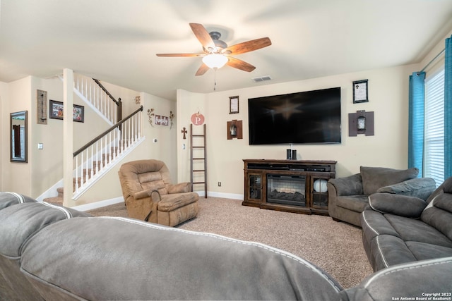 living room with ceiling fan and carpet floors