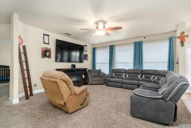 carpeted living room with a wealth of natural light and ceiling fan