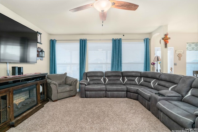 carpeted living room featuring ceiling fan