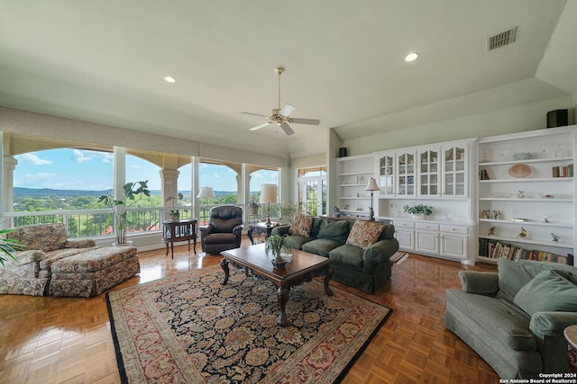 living room with parquet floors, ceiling fan, and lofted ceiling