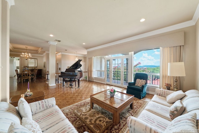 living room with parquet floors, decorative columns, a chandelier, and ornamental molding