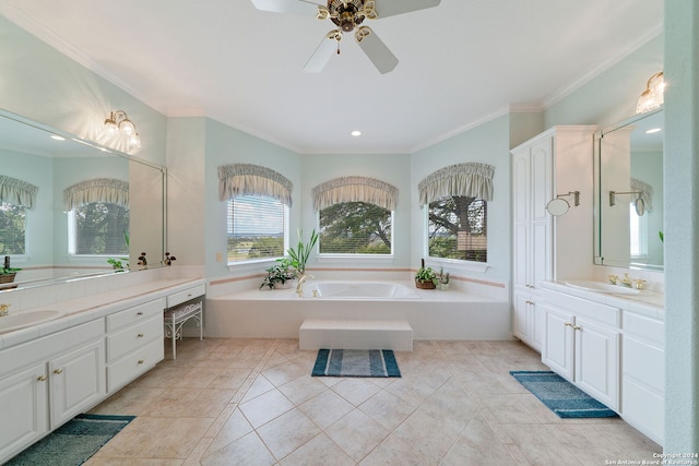 bathroom featuring a wealth of natural light, tiled bath, ceiling fan, and vanity