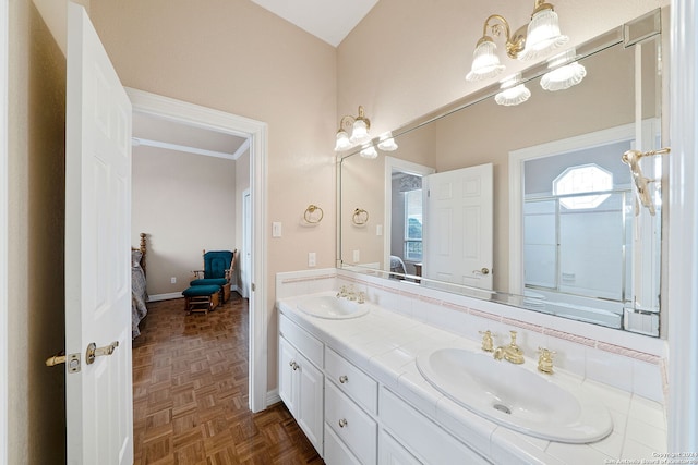 bathroom with ornamental molding, vanity, and parquet floors