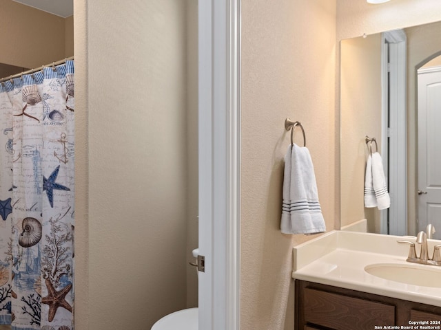 bathroom with vanity, toilet, and a shower with curtain