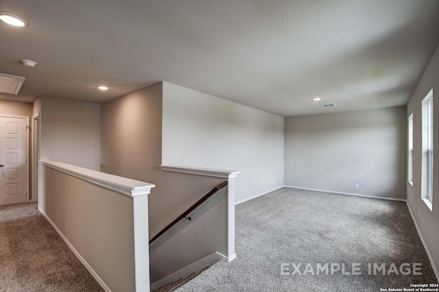 unfurnished room featuring recessed lighting, carpet, visible vents, and baseboards