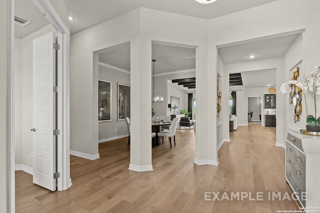 foyer entrance with light wood-type flooring and crown molding