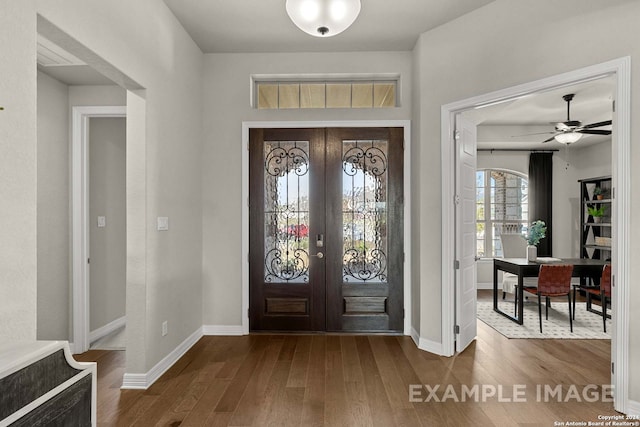 foyer with french doors, wood-type flooring, and ceiling fan