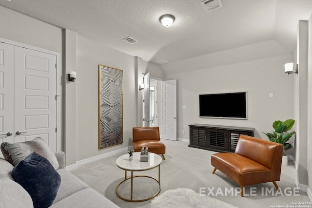 living room featuring a textured ceiling, vaulted ceiling, and light carpet